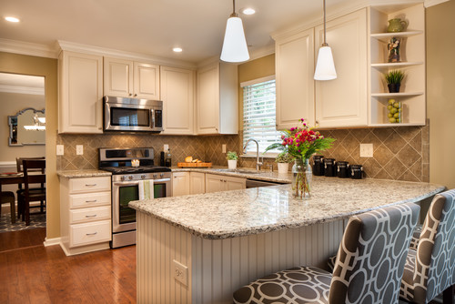 Giallo Napoli Countertop with Off White Kitchen Cabinets and Island and Gray Diagonal Ceramic Backsplash